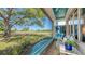 Relaxing sunroom with comfortable seating and a scenic view of the lush green backyard at 7782 Club Ln, Sarasota, FL 34238