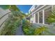 A beautiful walkway covered in lush tropical landscaping alongside the house at 7782 Club Ln, Sarasota, FL 34238