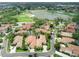 Aerial view showcases golf course, lakes, lush landscaping, and well-maintained homes at 8024 Via Fiore, Sarasota, FL 34238