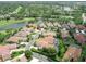 Aerial view showcases lakefront homes, golf course, and lush landscaping at 8024 Via Fiore, Sarasota, FL 34238