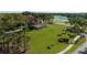 Aerial view of a landscaped community clubhouse with palm trees and immaculate lawns at 8024 Via Fiore, Sarasota, FL 34238