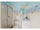 Bathroom features a shower and vanity sink with decorative beach-themed wallpaper border at 8024 Via Fiore, Sarasota, FL 34238