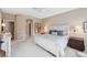 Spacious bedroom featuring neutral tones, plush carpet, and a view to the hallway and walk-in closet at 8024 Via Fiore, Sarasota, FL 34238