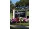 Prestancia community sign with colorful flowers in front on a sunny day at 8024 Via Fiore, Sarasota, FL 34238