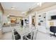 Open dining area with a view into the kitchen and built-in shelving and desk at 8024 Via Fiore, Sarasota, FL 34238