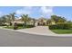 Beautiful Mediterranean home with lush landscaping, paver driveway, and tile roof in a sunny setting at 8024 Via Fiore, Sarasota, FL 34238