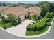 Stunning home with lush landscaping, terracotta roof, and a paver driveway at 8024 Via Fiore, Sarasota, FL 34238