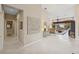 Bright and airy foyer with tile flooring, artwork, and a view into the living room at 8024 Via Fiore, Sarasota, FL 34238