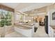 Spacious kitchen with granite countertops, white cabinets, and a breakfast bar at 8024 Via Fiore, Sarasota, FL 34238