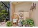 Cozy outdoor patio with wicker seating, tranquil water feature, and lush greenery for relaxation at 8024 Via Fiore, Sarasota, FL 34238