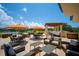 Outdoor patio with covered seating, tables, umbrellas, and scenic lake views at 8024 Via Fiore, Sarasota, FL 34238