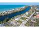 Expansive aerial shot showcases the home's location on a waterway near the beach, framed by lush Florida landscape at 8258 Midnight Pass Rd, Sarasota, FL 34242