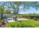 This backyard features a putting green, artificial grass, and a seating area with a fire pit at 8258 Midnight Pass Rd, Sarasota, FL 34242