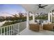 Inviting covered balcony with comfortable seating and scenic waterfront views at 8258 Midnight Pass Rd, Sarasota, FL 34242