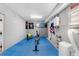 Finished basement featuring padded floors, storage, and exercise equipment at 8258 Midnight Pass Rd, Sarasota, FL 34242