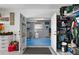 Basement, with a blue floor and white walls, storage racks, and open doorway at 8258 Midnight Pass Rd, Sarasota, FL 34242