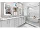 Elegant bathroom with double vanity, soaking tub, and glass-enclosed shower at 8258 Midnight Pass Rd, Sarasota, FL 34242