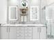 Elegant bathroom featuring double sinks with marble countertops, illuminated mirrors, and modern fixtures at 8258 Midnight Pass Rd, Sarasota, FL 34242