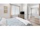 Comfortable bedroom featuring a dresser with TV, natural light, and coastal decor at 8258 Midnight Pass Rd, Sarasota, FL 34242