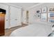 Bright bedroom with a closet, and a view into an en-suite bathroom and decoratively framed wall art at 8258 Midnight Pass Rd, Sarasota, FL 34242