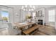 Elegant dining room featuring a stone fireplace and access to the outdoor patio at 8258 Midnight Pass Rd, Sarasota, FL 34242