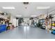 A spacious garage with ample storage space and organization, featuring gray flooring and modern lighting at 8258 Midnight Pass Rd, Sarasota, FL 34242