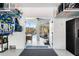 Garage entry featuring a view to the outdoor pool with seating and a ceiling fan at 8258 Midnight Pass Rd, Sarasota, FL 34242