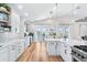 Gourmet kitchen with white cabinetry, eat-in island and access to the balcony for indoor/outdoor living at 8258 Midnight Pass Rd, Sarasota, FL 34242