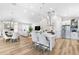 Open concept featuring an eat-in kitchen island, stainless appliances, and view to the dining and living area at 8258 Midnight Pass Rd, Sarasota, FL 34242