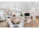 Bright, open-concept living and dining area with fireplace and modern chandelier at 8258 Midnight Pass Rd, Sarasota, FL 34242