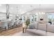 Open-concept living space with a kitchen bar, dining area, and comfortable seating at 8258 Midnight Pass Rd, Sarasota, FL 34242