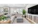 Comfortable living area with neutral tones, modern entertainment center, and plenty of natural light at 8258 Midnight Pass Rd, Sarasota, FL 34242