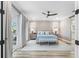 Relaxing main bedroom with a view to the outdoors and a barn door leading to the bathroom at 8258 Midnight Pass Rd, Sarasota, FL 34242