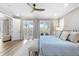 Bright main bedroom with exterior access and seating area at 8258 Midnight Pass Rd, Sarasota, FL 34242