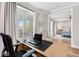 Home office with French doors and views to the outside; bedroom in background at 8258 Midnight Pass Rd, Sarasota, FL 34242