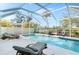 Outdoor pool area featuring a covered patio with lounge chairs and privacy fence at 8258 Midnight Pass Rd, Sarasota, FL 34242