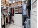 Organized walk-in closet with custom shelving and storage solutions at 8258 Midnight Pass Rd, Sarasota, FL 34242