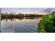 Water view with a glimpse of a dock surrounded by lush greenery at sunset at 8258 Midnight Pass Rd, Sarasota, FL 34242