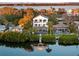 Waterfront home showcasing its multi-level balconies, private dock, lush landscaping, and serene water views at 8258 Midnight Pass Rd, Sarasota, FL 34242