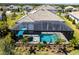 Stunning aerial view of a private pool, lanai, and lush landscaping, ideal for relaxation at 8265 Pavia Way, Bradenton, FL 34202