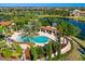 Aerial view showcasing the pool and pergola area with lush tropical landscaping in the community at 8265 Pavia Way, Bradenton, FL 34202