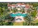 Aerial view of grand pool area with lounge seating and palm trees surrounding an elegant community center at 8265 Pavia Way, Bradenton, FL 34202