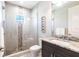 Modern bathroom showcasing a glass-enclosed shower with decorative tile accents and a stylish vanity area at 8265 Pavia Way, Bradenton, FL 34202
