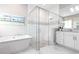 Bright bathroom featuring a soaking tub and glass shower with decorative tile at 8265 Pavia Way, Bradenton, FL 34202