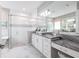 Bright bathroom featuring a soaking tub, glass shower, and vanity with granite countertops at 8265 Pavia Way, Bradenton, FL 34202