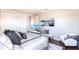 Serene bedroom features soft gray tones, comfortable seating, and a hidden pop-up television at 8265 Pavia Way, Bradenton, FL 34202