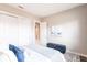 Comfortable bedroom with a storage bench, closet, and a neutral color palette at 8265 Pavia Way, Bradenton, FL 34202