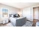 Serene bedroom with a plush gray bed, stylish nightstands, and soft lighting, offering a relaxing retreat at 8265 Pavia Way, Bradenton, FL 34202