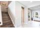 Elegant entryway featuring hardwood stairs and marble flooring, leading to a welcoming foyer at 8265 Pavia Way, Bradenton, FL 34202