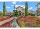 Beautiful community building with lush landscaping, colorful flowers, and brick-paved walkway at 8265 Pavia Way, Bradenton, FL 34202